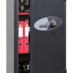 The Phoenix safe planet hs6074e is a euro grade 4 high security safe. Generally used as a commercial safe, retail safe, jeweller safe or even a domestic safe. It is tested by ECB.S and certified to store £60,000 over night or up to £600,000 of jewellery subject to insurers confirmation. The image shows the safe door open and a glimpse of suggested content. Its size is 1210mm tall, finished in graphite grey with red shelves. This formidable security safe comes with vds class 2 key and electronic code locks
