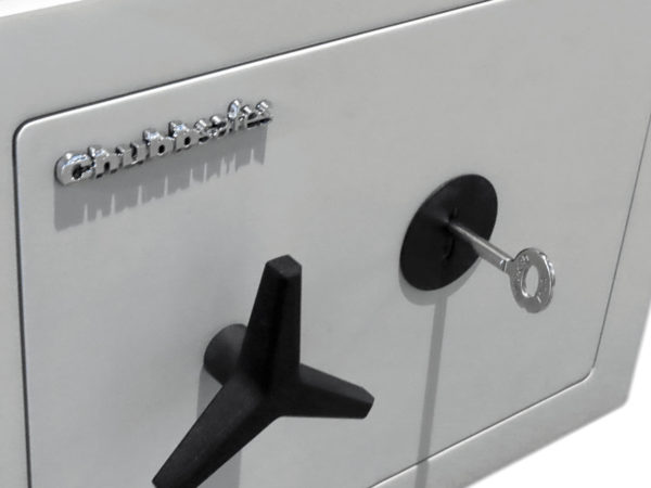 Chubbsafes HomeVault S2 25KL shown with the key in its lock and its 3 wheel propeller style handle to open/close its door bolts.
